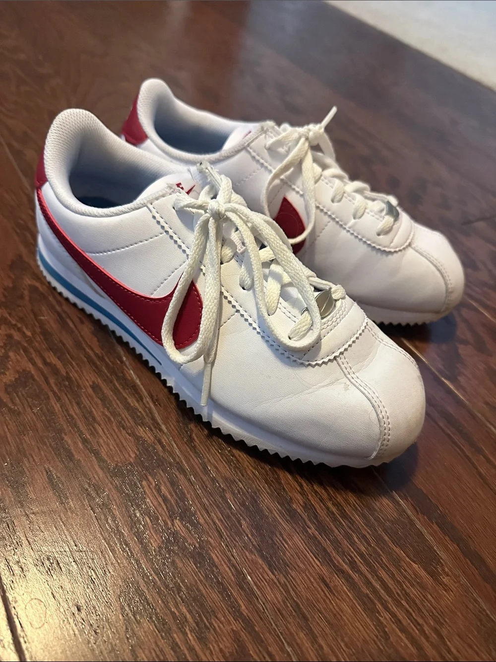 Nike Kids White Sneakers with Red Swoosh
